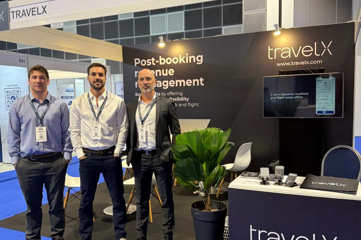 TravelX team at an industry conference booth showcasing post-booking revenue management